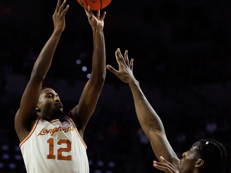 Jan 18, 2025; Gainesville, Florida, USA; Texas Longhorns guard Tramon Mark (12) shoots over Florida Gators center Rueben Chinyelu (9) during the first half at Exactech Arena at the Stephen C. O'Connell Center. Mandatory Credit: Matt Pendleton-Imagn Images