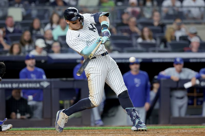 Sep 9, 2024; Bronx, New York, USA; New York Yankees designated hitter Aaron Judge (99) follows through on an RBI single against the Kansas City Royals during the seventh inning at Yankee Stadium. Mandatory Credit: Brad Penner-Imagn Images