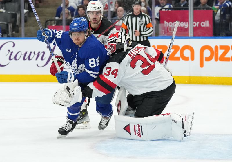 Mar 26, 2024; Toronto, Ontario, CAN; Toronto Maple Leafs right wing William Nylander (88) battles with New Jersey Devils goaltender Jake Allen (34) during the first period at Scotiabank Arena. Mandatory Credit: Nick Turchiaro-USA TODAY Sports