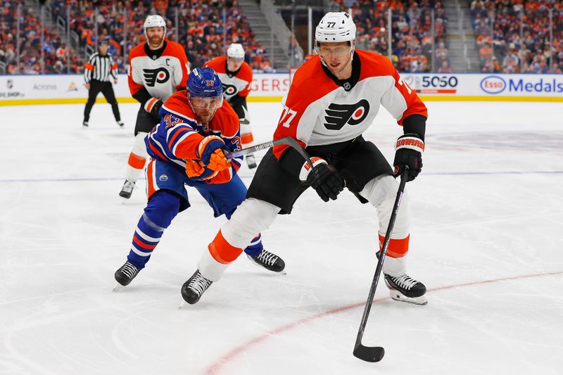 Oct 15, 2024; Edmonton, Alberta, CAN; Philadelphia Flyers defensemen Erik Johnson (77) and Edmonton Oilers forward Victor Arvidsson (33) chase a loose puck during the third period at Rogers Place. Mandatory Credit: Perry Nelson-Imagn Images