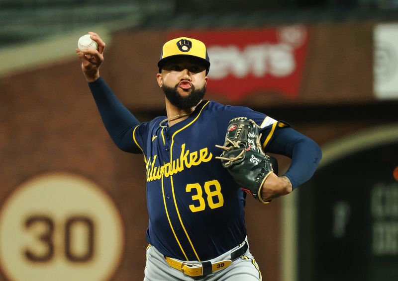 Sep 12, 2024; San Francisco, California, USA; Milwaukee Brewers relief pitcher Devin Williams (38) pitches the ball against the San Francisco Giants during the ninth inning at Oracle Park. Mandatory Credit: Kelley L Cox-Imagn Images