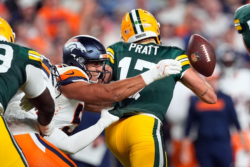 Green Bay Packers quarterback Michael Pratt (17) fumbles the ball against Denver Broncos linebacker Jonah Elliss (52) during the second half of a preseason NFL football game, Sunday, Aug. 18, 2024, in Denver. (AP Photo/David Zalubowski)