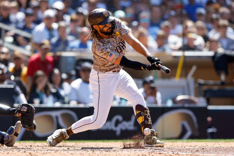 May 26, 2024; San Diego, California, USA; San Diego Padres right fielder Fernando Tatis Jr. (23) hits a rbi infield single in the sixth inning against the New York Yankees at Petco Park. Mandatory Credit: David Frerker-USA TODAY Sports