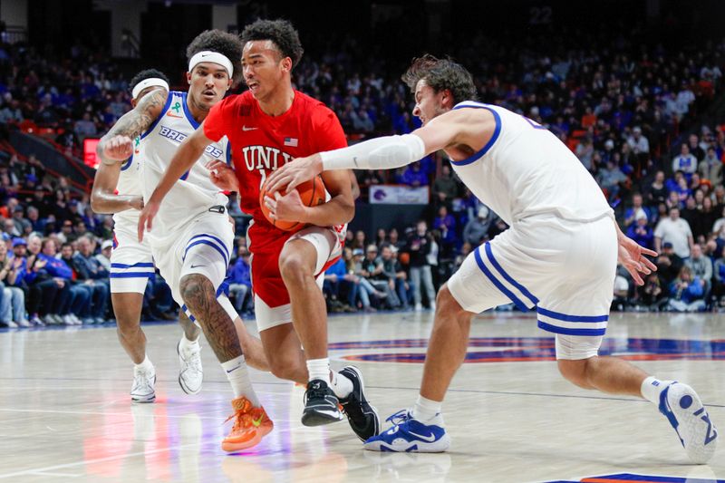 Jan 16, 2024; Boise, Idaho, USA; UNLV Rebels guard Dedan Thomas Jr. (11) drives against Boise State Broncos forward Tyson Degenhart (2) during the first half at ExtraMile Arena. Mandatory Credit: Brian Losness-USA TODAY Sports

