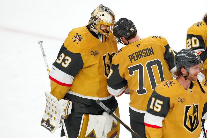 Mar 22, 2025; Las Vegas, Nevada, USA; Vegas Golden Knights goaltender Adin Hill (33) is congratulated by Vegas Golden Knights left wing Tanner Pearson (70) after the Golden Knights defeated the Detroit Red Wings 6-3 at T-Mobile Arena. Mandatory Credit: Stephen R. Sylvanie-Imagn Images