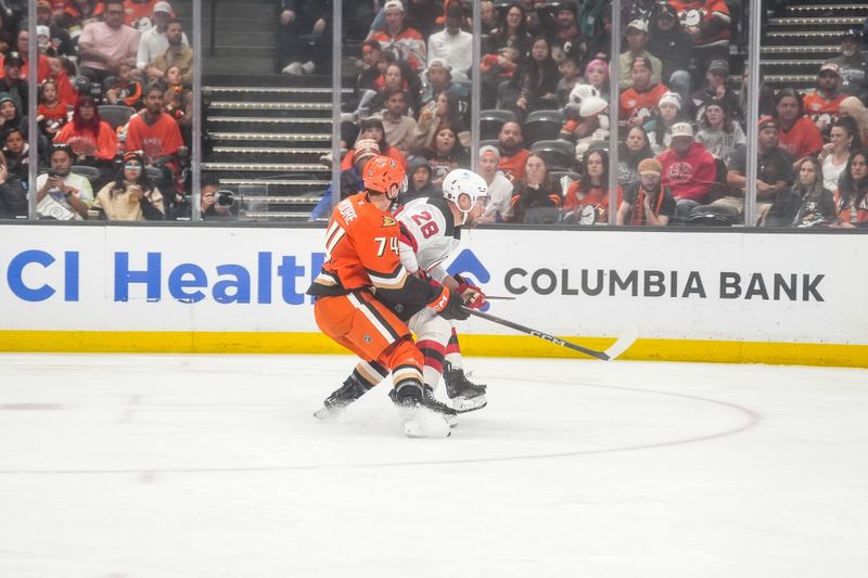 Nov 2, 2025; Anaheim, California, USA;  Anaheim Ducks defenseman Ian Moore (74) defends against New Jersey Devils right wing Timo Meier (28) in an attempt to score during the second period at Honda Center. Mandatory Credit: Corinne Votaw-Imagn Images