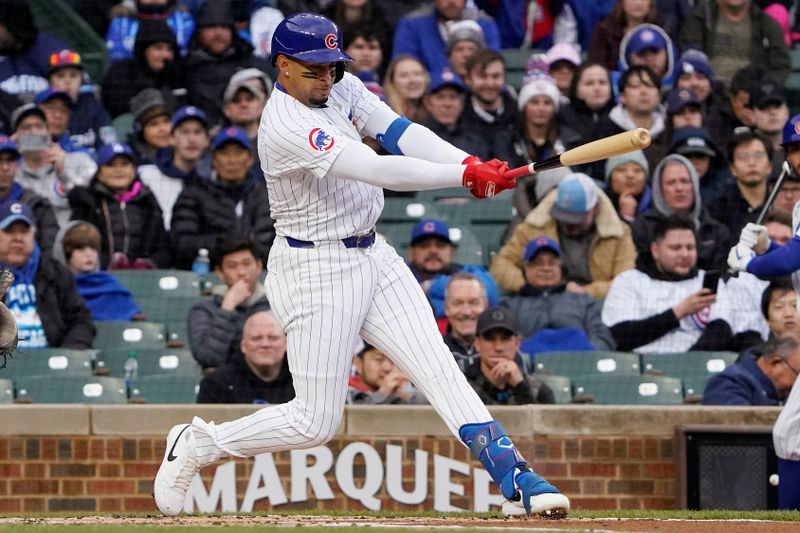 Apr 7, 2024; Chicago, Illinois, USA; Chicago Cubs third baseman Christopher Morel (5) hits a single against the Los Angeles Dodgers during the first inning at Wrigley Field. Mandatory Credit: David Banks-USA TODAY Sports