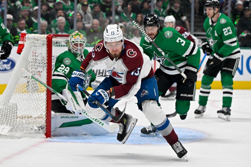 May 9, 2024; Dallas, Texas, USA; Colorado Avalanche right wing Valeri Nichushkin (13) and Dallas Stars defenseman Chris Tanev (3) chase the puck as goaltender Jake Oettinger (29) looks on during the first period in game two of the second round of the 2024 Stanley Cup Playoffs at American Airlines Center. Mandatory Credit: Jerome Miron-USA TODAY Sports