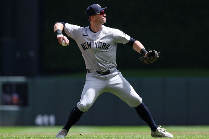 May 16, 2024; Minneapolis, Minnesota, USA; New York Yankees third baseman Jon Berti (19) throws the ball to first base to get out Minnesota Twins Willi Castro (50) during the second inning at Target Field. Mandatory Credit: Matt Krohn-USA TODAY Sports