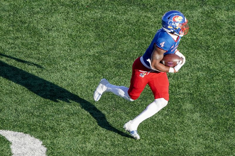 Nov 5, 2022; Lawrence, Kansas, USA; Kansas Jayhawks running back Devin Neal (4) runs the ball against the Oklahoma State Cowboys during the second half of the game at David Booth Kansas Memorial Stadium. Mandatory Credit: Denny Medley-USA TODAY Sports