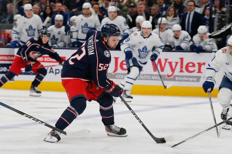 Dec 29, 2023; Columbus, Ohio, USA; Columbus Blue Jackets center Emil Bemstrom (52) carries the puck against the Toronto Maple Leafs during the first period at Nationwide Arena. Mandatory Credit: Russell LaBounty-USA TODAY Sports