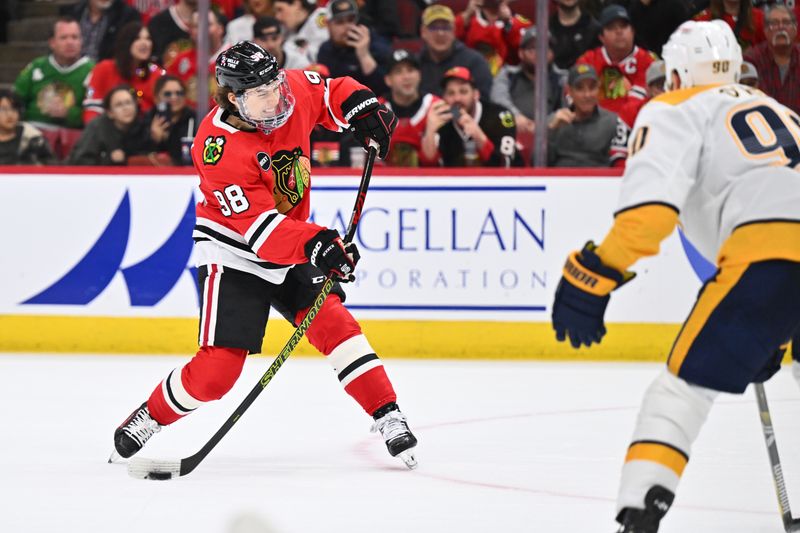 Apr 12, 2024; Chicago, Illinois, USA; Chicago Blackhawks forward Connor Bedard (98) attempts a shot on the power play in the second period against the Nashville Predators at United Center. Mandatory Credit: Jamie Sabau-USA TODAY Sports