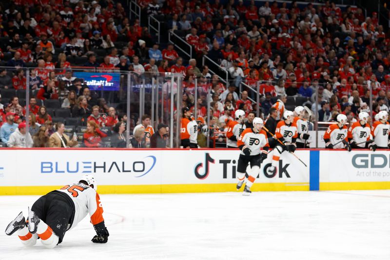 Oct 23, 2024; Washington, District of Columbia, USA; Philadelphia Flyers center Ryan Poehling (25) attempts to crawl back to the bench after being injured blocking a shot against the Washington Capitals in the third period at Capital One Arena. Mandatory Credit: Geoff Burke-Imagn Images