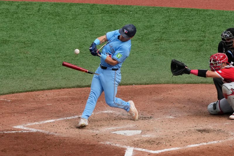 Aug 24, 2024; Toronto, Ontario, CAN; Toronto Blue Jays center fielder Daulton Varsho (25) breaks his bat as he makes contact with the ball against the Los Angeles Angels during the seventh inning at Rogers Centre. Mandatory Credit: John E. Sokolowski-USA TODAY Sports