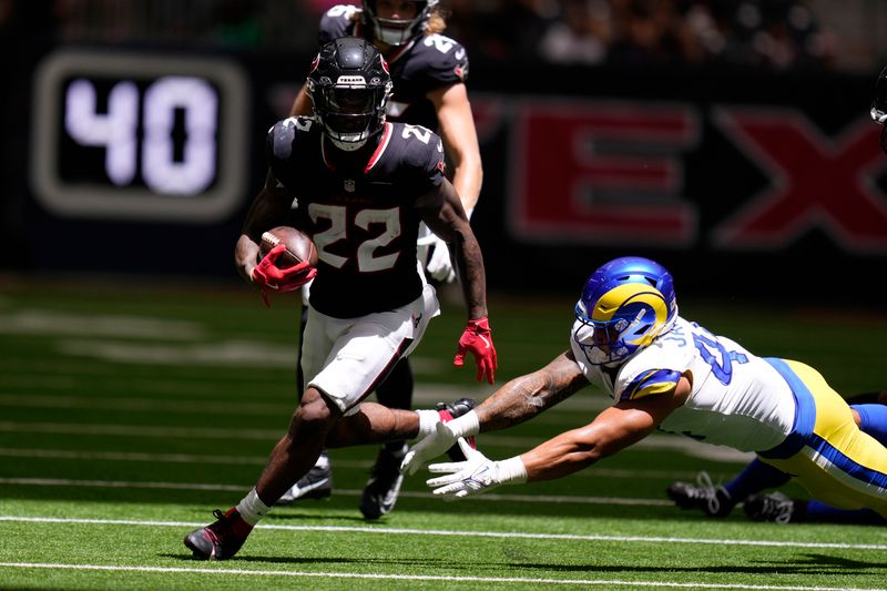 Houston Texans running back Cam Akers (22) runs from Los Angeles Rams linebacker Brennan Jackson (44) during the first half of a preseason NFL football game, Saturday, Aug. 24, 2024, in Houston. (AP Photo/Eric Christian Smith)