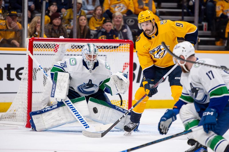 Apr 26, 2024; Nashville, Tennessee, USA; Vancouver Canucks goaltender Casey DeSmith (29) blocks the deflection of Nashville Predators left wing Filip Forsberg (9) during the third period in game three of the first round of the 2024 Stanley Cup Playoffs at Bridgestone Arena. Mandatory Credit: Steve Roberts-USA TODAY Sports