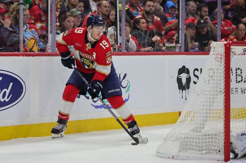 Oct 22, 2024; Sunrise, Florida, USA; Florida Panthers left wing Matthew Tkachuk (19) moves the puck against the Minnesota Wild during the second period at Amerant Bank Arena. Mandatory Credit: Sam Navarro-Imagn Images