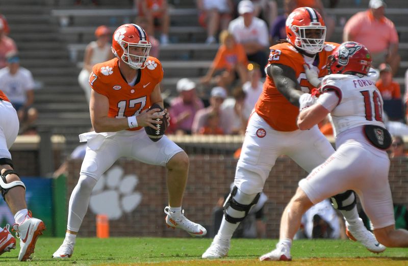 Sep 21, 2024; Clemson, South Carolina, USA; Clemson Tigers quarterback Christopher Vizzina (17) runs against North Carolina State Wolfpack linebacker Caden Fordham (10) during the third quarter at Memorial Stadium. Mandatory Credit: Ken Ruinard-Imagn Images