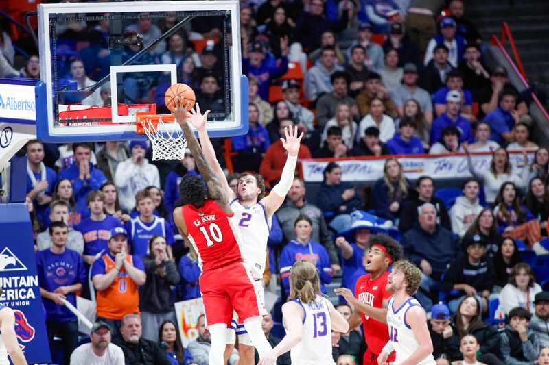 Jan 16, 2024; Boise, Idaho, USA; UNLV Rebels forward Kalib Boone (10) drives to the basket over Boise State Broncos forward Tyson Degenhart (2) during the second half at ExtraMile Arena. UNLV beats Boise State 68-64. Mandatory Credit: Brian Losness-USA TODAY Sports

