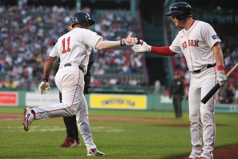 May 16, 2024; Boston, Massachusetts, USA;  Boston Red Sox third baseman Rafael Devers (11) celebrates a home run with designated hitter Garrett Cooper (28) during the second inning against the Tampa Bay Rays at Fenway Park. Mandatory Credit: Eric Canha-USA TODAY Sports