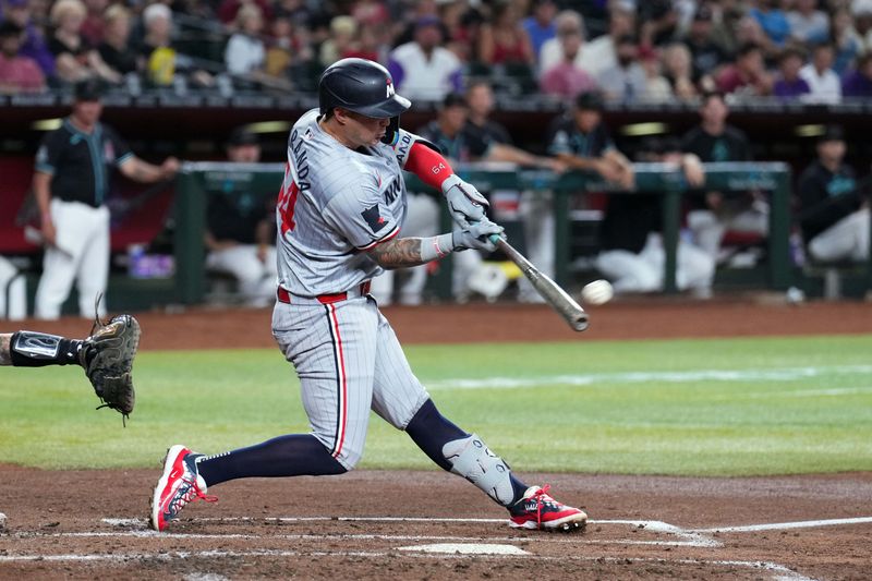 Jun 26, 2024; Phoenix, Arizona, USA; Minnesota Twins third base Jose Miranda (64) hits a three RBI double against the Arizona Diamondbacks during the second inning at Chase Field. Mandatory Credit: Joe Camporeale-USA TODAY Sports