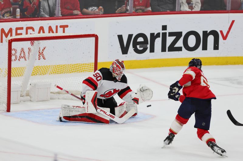 Jan 13, 2024; Sunrise, Florida, USA; New Jersey Devils goaltender Nico Daws (50) defends his net against Florida Panthers defenseman Brandon Montour (62) during the third period at Amerant Bank Arena. Mandatory Credit: Sam Navarro-USA TODAY Sports