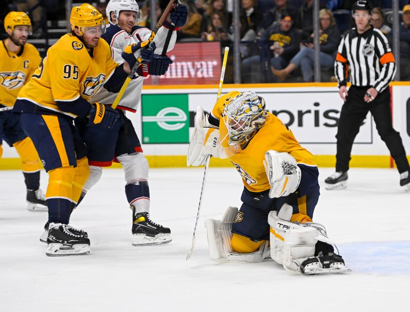 Jan 17, 2023; Nashville, Tennessee, USA;  Nashville Predators goaltender Kevin Lankinen (32) makes a glove save against the Columbus Blue Jackets during the second period at Bridgestone Arena. Mandatory Credit: Steve Roberts-USA TODAY Sports