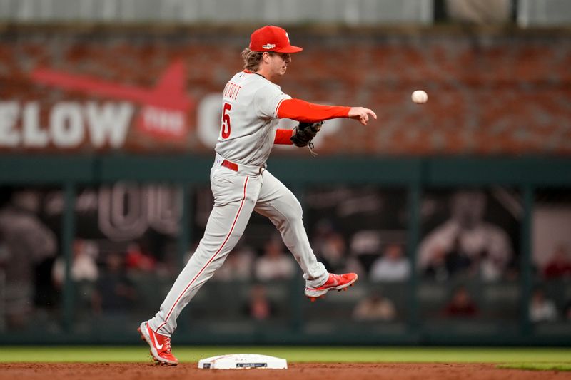 Oct 12, 2022; Atlanta, Georgia, USA; Philadelphia Phillies shortstop Bryson Stott (5) fields the ball and throws out Atlanta Braves third baseman Austin Riley (27) in the second inning during game two of the NLDS for the 2022 MLB Playoffs at Truist Park. Mandatory Credit: Dale Zanine-USA TODAY Sports