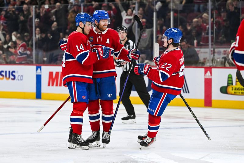 Dec 2, 2023; Montreal, Quebec, CAN; Montreal Canadiens center Nick Suzuki (14) celebrates his goal against the Detroit Red Wings with defenseman Mike Matheson (8) and right wing Cole Caufield (22) during the third period at Bell Centre. Mandatory Credit: David Kirouac-USA TODAY Sports