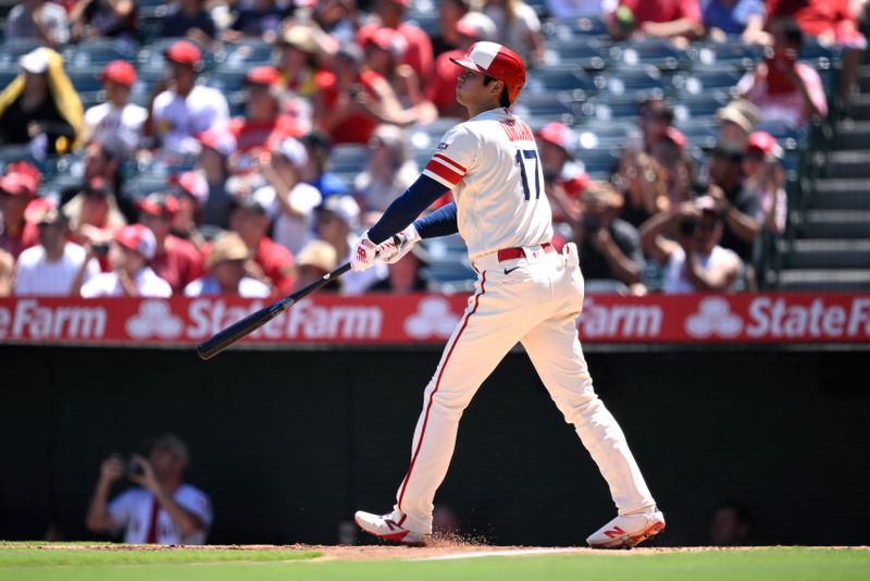 Aug 23, 2023; Anaheim, California, USA; Los Angeles Angels starting pitcher Shohei Ohtani (17) hits a two-run home run against the Cincinnati Reds during the first inning at Angel Stadium. Mandatory Credit: Orlando Ramirez-USA TODAY Sports