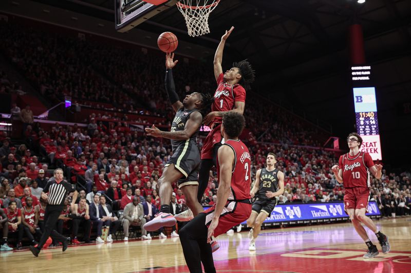 Jan 28, 2024; Piscataway, New Jersey, USA; Purdue Boilermakers guard Lance Jones (55) shoots the ball as Rutgers Scarlet Knights guard Jamichael Davis (1) and guard Noah Fernandes (2) defends during the first half at Jersey Mike's Arena. Mandatory Credit: Vincent Carchietta-USA TODAY Sports