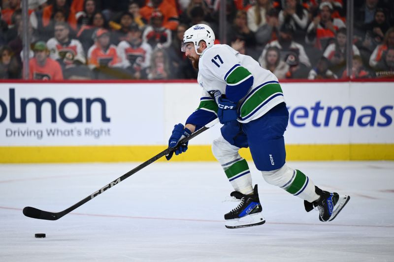 Oct 19, 2024; Philadelphia, Pennsylvania, USA; Vancouver Canucks defenseman Filip Hronek (17) controls the puck against the Philadelphia Flyers in the second period at Wells Fargo Center. Mandatory Credit: Kyle Ross-Imagn Images