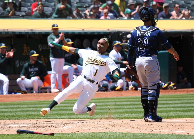 Jun 15, 2023; Oakland, California, USA; Oakland Athletics center fielder Esteury Ruiz (1) slides safely home behind Tampa Bay Rays catcher Francisco Mejia (21) during the fifth inning at Oakland-Alameda County Coliseum. Mandatory Credit: Kelley L Cox-USA TODAY Sports