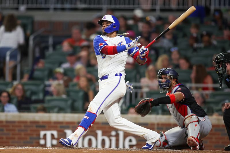 Aug 24, 2024; Atlanta, Georgia, USA; Atlanta Braves shortstop Orlando Arcia (11) hits a home run against the Washington Nationals in the fifth inning at Truist Park. Mandatory Credit: Brett Davis-USA TODAY Sports