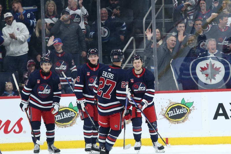 Nov 18, 2023; Winnipeg, Manitoba, CAN; Winnipeg Jets forward Vladislav Namestnikov (7) is congratulated by his team mates on his goal against the Arizona Coyotes during the first period at Canada Life Centre. Mandatory Credit: Terrence Lee-USA TODAY Sports