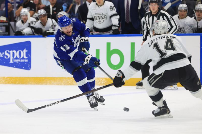 Dec 18, 2025; Tampa, Florida, USA; Tampa Bay Lightning defenseman Darren Raddysh (43) passes the puck as Los Angeles Kings right wing Alex Laferriere (14) defends during the first period at Benchmark International Arena. Mandatory Credit: Kim Klement Neitzel-Imagn Images