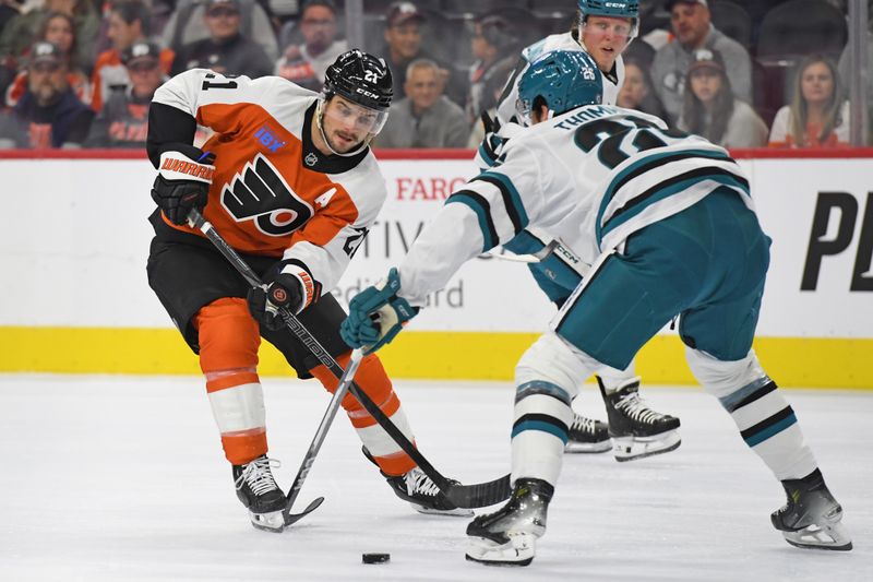 Nov 11, 2024; Philadelphia, Pennsylvania, USA; Philadelphia Flyers center Scott Laughton (21) is defended by San Jose Sharks defenseman Jack Thompson (26) during the first period at Wells Fargo Center. Mandatory Credit: Eric Hartline-Imagn Images