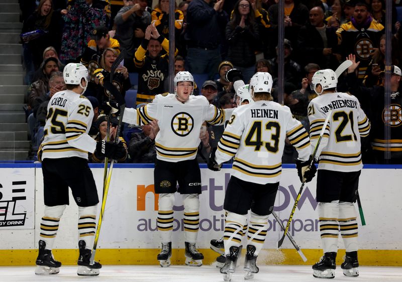 Dec 27, 2023; Buffalo, New York, USA;  Boston Bruins defenseman Mason Lohrei (6) celebrates his goal with teammates during the first period against the Buffalo Sabres at KeyBank Center. Mandatory Credit: Timothy T. Ludwig-USA TODAY Sports