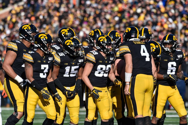 Nov 23, 2019; Iowa City, IA, USA; Iowa Hawkeyes quarterback Nate Stanley (4) calls the play with wide receiver Nico Ragaini (89) and running back Tyler Goodson (15) and teammates against the Illinois Fighting Illini during the fourth quarter at Kinnick Stadium. Mandatory Credit: Jeffrey Becker-USA TODAY Sports