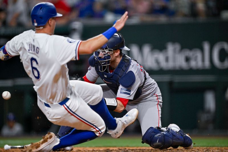 Aug 3, 2024; Arlington, Texas, USA;  Boston Red Sox catcher Danny Jansen (28) tags out Texas Rangers third baseman Josh Jung (6) at home plate during the sixth inning at Globe Life Field. Mandatory Credit: Jerome Miron-USA TODAY Sports