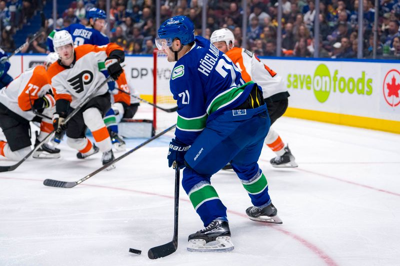 Oct 11, 2024; Vancouver, British Columbia, CAN; Vancouver Canucks forward Nils Hoglander (21) handles the puck against the Philadelphia Flyers during the third period at Rogers Arena. Mandatory Credit: Bob Frid-Imagn Images