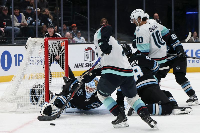 Dec 12, 2025; Salt Lake City, Utah, USA; Utah Mammoth goaltender Karel Vejmelka (70) dives for the puck as Seattle Kraken right wing Jordan Eberle (7) tries to make a play during the third period at Delta Center. Mandatory Credit: Rob Gray-Imagn Images