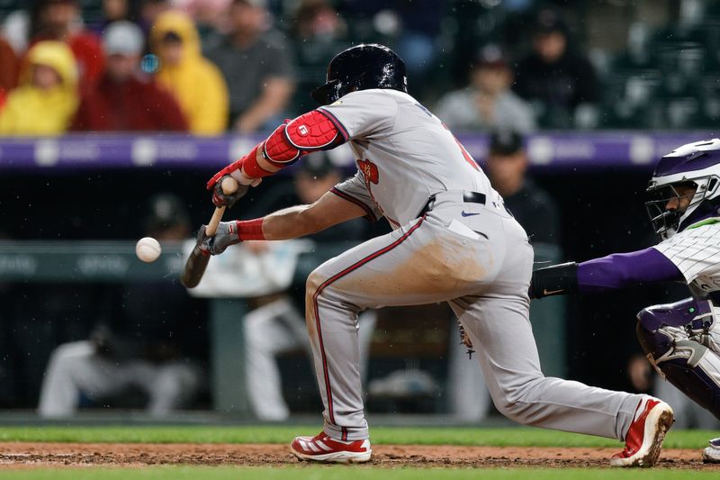 Aug 9, 2024; Denver, Colorado, USA; Atlanta Braves second baseman Whit Merrifield (15) bunts in the ninth inning against the Colorado Rockies at Coors Field. Mandatory Credit: Isaiah J. Downing-USA TODAY Sports