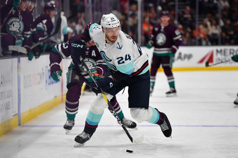 Apr 5, 2024; Anaheim, California, USA; Seattle Kraken defenseman Jamie Oleksiak (24) moves the puck against the Anaheim Ducks during the second period at Honda Center. Mandatory Credit: Gary A. Vasquez-USA TODAY Sports