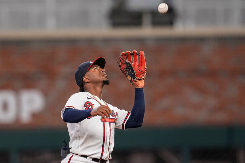 Apr 12, 2023; Cumberland, Georgia, USA; Atlanta Braves second baseman Ozzie Albies (1) catches a pop up hit by Cincinnati Reds batter Stuart Fairchild (17) (not shown) during the ninth inning at Truist Park. Mandatory Credit: Dale Zanine-USA TODAY Sports