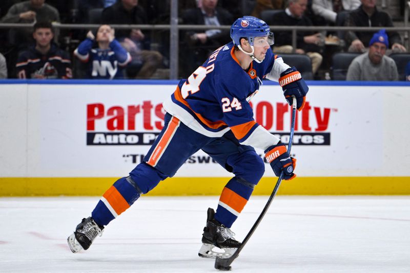 Dec 7, 2023; Elmont, New York, USA; New York Islanders defenseman Scott Mayfield (24) passes the puck against the New York Islanders during the first period at UBS Arena. Mandatory Credit: John Jones-USA TODAY Sports