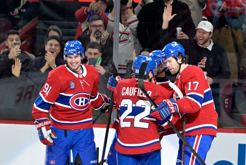 Jan 25, 2024; Montreal, Quebec, CAN; Montreal Canadiens forward Sean Monahan (91) celebrates with teammates including forward Cole Caufield (22) and forward Josh Anderson (17) after scoring a goal against the New York Islanders during the third period at the Bell Centre. Mandatory Credit: Eric Bolte-USA TODAY Sports
