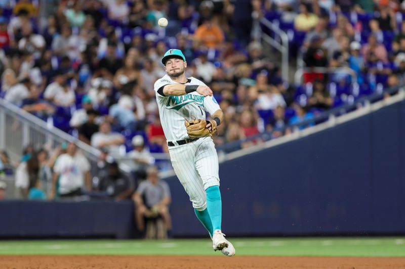 Sep 22, 2023; Miami, Florida, USA; Miami Marlins center fielder Garrett Hampson (1) throws to first base and retires Milwaukee Brewers third baseman Josh Donaldson (not pictured) during the second inning at loanDepot Park. Mandatory Credit: Sam Navarro-USA TODAY Sports