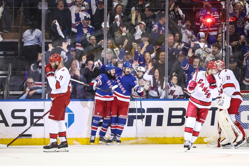 May 5, 2024; New York, New York, USA; New York Rangers center Mika Zibanejad (93) celebrates with New York Rangers left wing Chris Kreider (20) after scoring his second goal of the game in the first period against the Carolina Hurricanes in game one of the second round of the 2024 Stanley Cup Playoffs at Madison Square Garden. Mandatory Credit: Wendell Cruz-USA TODAY Sports