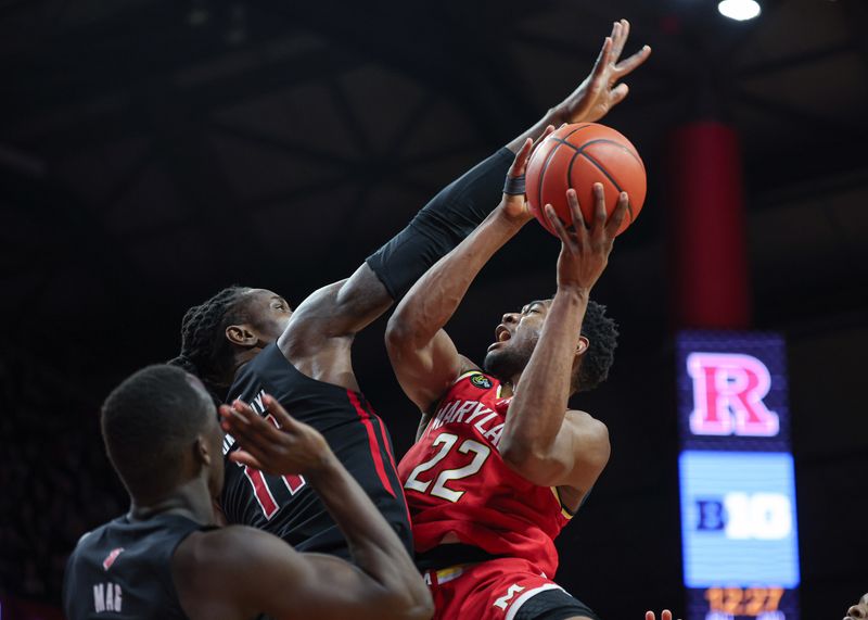 Feb 25, 2024; Piscataway, New Jersey, USA; Maryland Terrapins forward Jordan Geronimo (22) drives for a shot as Rutgers Scarlet Knights center Clifford Omoruyi (11) and forward Mawot Mag (3) defend during the first half at Jersey Mike's Arena. Mandatory Credit: Vincent Carchietta-USA TODAY Sports